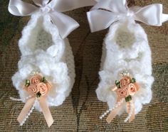 two pairs of baby shoes with bows and flowers on the bottom one pair is made from crochet