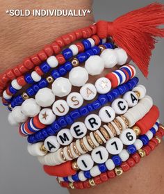 the bracelets are all different colors and designs on each one side, with an american flag tassel