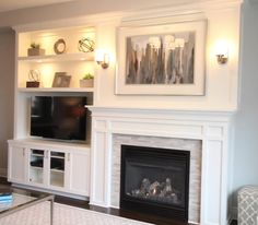 a living room filled with furniture and a flat screen tv mounted on a wall above a fire place