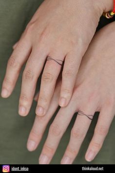 a woman's hand with a small tattoo on it