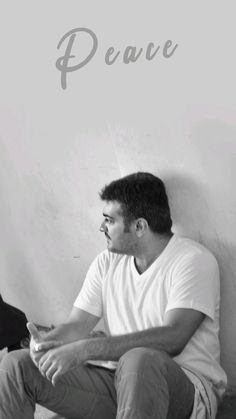 black and white photograph of man sitting on the floor with words above him that say peace