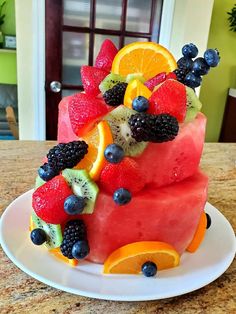 a watermelon cake with fruit on top