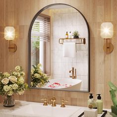 a bathroom with a sink, mirror and flowers in the vase on the counter top