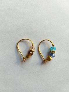 two pairs of gold - plated earrings with multicolored glass beads on them