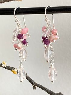 This pair of elegant shimmering sterling silver (925) drop earrings have been intricately crafted with beads hand wrapped onto silver and mounted like a cascade on a small silver chain. The stones are as follows: 2 faceted drops of rose quartz (size approx. 5 x 9 mm), 3 buttons each made of rhodochrosite (size 3 x 6 mm), 3 faceted beads made of rock crystal (diameter approx. 4 mm), 2 dice each of dark red, luminous ruby and 1 faceted button made of rhodochrosite (size approx. 3 x 4 mm). The earrings have a length of 5.5 cm. The ear hooks are 1.5 cm long, the pendants 4 cm. All silver parts used are sterling silver. The stones used as healing stones are also said to have a certain effect: Rose Quartz is the stone for the heart - it represents compassion, love, unconditional love, self-love Elegant Pink Sterling Silver Crystal Earrings, Pink Stone Earrings, Rose Quartz Gemstone Dangle Earrings, Pink Multi-stone Earrings For Gift, Pink Rose Quartz Earrings With Natural Stones, Rhodochrositee Earrings, Cluster Earrings, Pink Stone, Rock Crystal