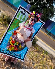 a woman dressed as a clown holding a sign