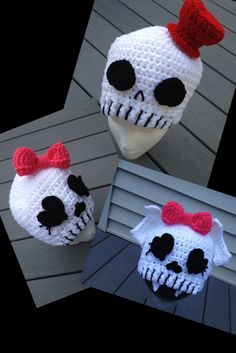 three crocheted skulls with bows on their heads, one is white and the other is red