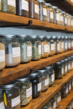 the shelves are filled with many different types of spices and seasonings in glass jars