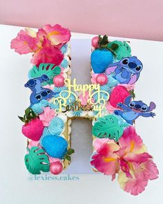 a birthday card with the letter h decorated in flowers