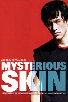 a young man is standing in front of a red background with the words mysterious skin on it