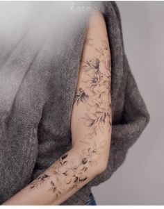 a woman's arm with flowers on it