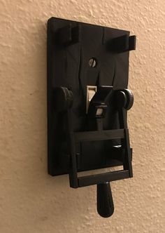 an electrical device mounted to the side of a wall with one light switch on it