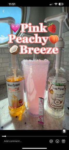 the pink peachy breezee is next to two glasses and a bottle of liquid