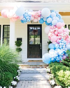 the entrance to a house decorated with balloons