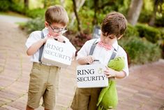 two young boys are holding bags that say ring security and king security with the same word on them