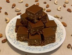 several pieces of chocolate and nuts on a plate