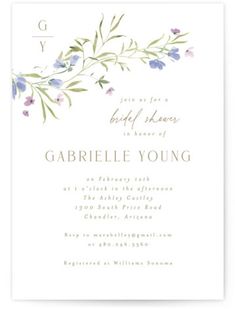 an elegant floral wedding card with purple flowers and greenery