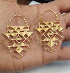 18k Solid Gold Handmade and Handcraftet Dangling Geometric Hoops, Dangling Bell decorated with Mutiple Triangles in Rajasthani Art way. Rajasthani Gold Jewelry, Indian Gold Dangling Hoops, Big Gold Hoops * Metal: 18k Solid Gold ( Hallmarked ) * Pure and Genuine 18k Gold ( Hallmarked ) * Weight: 20 Gram ( approx) * Wide: 42mm * Total Length: 46mm long One of a kind amazing Gold Hoops with Rajasthan Art In Various Triangle on it in . We welcome custom orders as well. Gold jewelry comes in gift box Designer Gold Brass Jewelry, Elegant Ceremonial Earrings With Motifs, Traditional Wedding Jewelry With Unique Design, Designer Handmade Wedding Jewelry, Gold Bohemian Earrings For Navratri, Handmade Yellow Gold Jewelry For Festivals, Handmade Yellow Gold Festive Jewelry, Festive Designer Jewelry With Intricate Design, Designer Gold Jewelry For Celebration