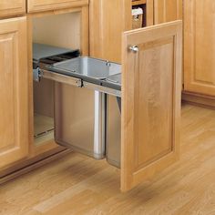 an open cabinet door in a kitchen with wooden cabinets and stainless steel dishwasher