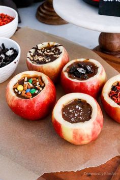 there are some apples with different toppings on them