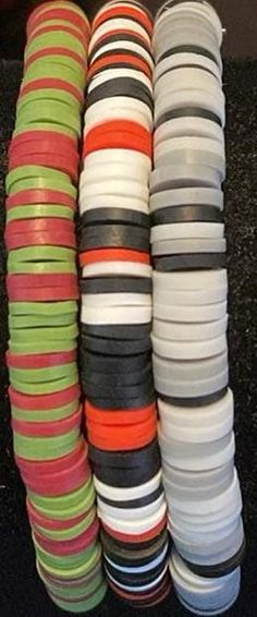 many different colored bracelets stacked on top of each other