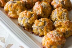 a white plate topped with meatballs on top of a table