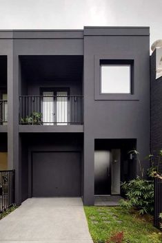 an apartment building with two balconies on the second floor