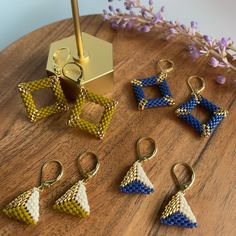 six pairs of earrings sitting on top of a wooden table