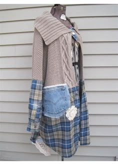 a jacket made out of old jeans is hanging on a clothes rack in front of a house