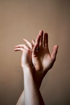 a person's hand reaching up into the air