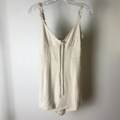 Spaghetti Strap Cream Romper With Front Tie Never Worn Summer Lounge Tank Top With Straps, Summer Tank Top With Straps For Loungewear, Summer Loungewear Strapped Camisole, Summer Loungewear Camisole With Straps, Summer Camisole For Loungewear, Summer Beige Camisole For Daywear, Beige Camisole For Summer Daywear, Spring Spaghetti Strap Camisole, Spaghetti Strap