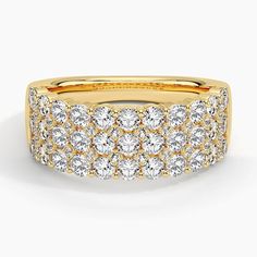 a yellow gold ring with rows of round diamonds on the sides and two rows of smaller diamond