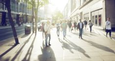 many people are walking down the street together