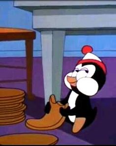 a cartoon penguin with a santa hat and boots in front of stacks of plates on the floor