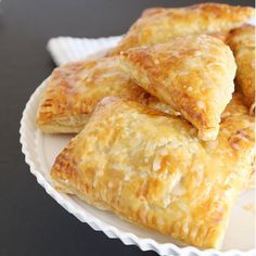 three pastries sitting on top of a white plate