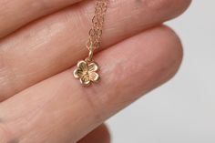 Solid 14k gold cherry blossom charm necklace. A delicate and beautifully detailed charm. Cherry blossoms are a symbolic flower of spring, a time of renewal, and the fleeting nature of life. In Japanese culture the cherry blossom represents the fragility and the beauty of life. Available with a solid gold chain, gold filled chain or as a charm only. Charm comes with a 4mm jump ring, if you would like to add clasp to add to your charm bracelet here is the link. https://www.etsy.com/listing/1021468 Dainty Flower Necklace, Chinese Cherry Blossom, Japanese Necklace, Cherry Blossom Jewelry, Cherry Blossom Necklace, Solid Gold Charms, Bee Necklace, Solid Gold Chains, Fancy Jewellery