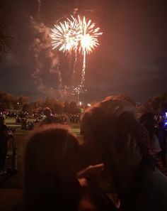 two people are kissing in front of fireworks