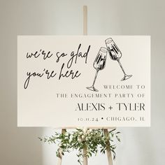 a sign that says, we're so glad you're here welcome to the engagement party of alex & tyler chicago