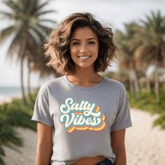 ♥ ♥ ♥ PRINT AND SHIP FROM USA ♥ ♥ ♥    Salty Vibes Shirt, Salty Beach Shirt, Summer Shirt, Beach Party Tee, Summer Vibes Shirt, Palm T-shirt, Beach T-Shirt, Holiday Vibes MADE TO ORDER  This listing is for ONE UNISEX BELLA CANVAS tees with the design as seen in the listing picture. SIZING: -Easy measuring tip: Take you favorite sweatshirt or tee, lay it on a flat surface and measure the width (armpit to armpit) and length (top to bottom), then compare with my size chart! -Shirts are UNISEX. Sinc Summer Relaxed Fit T-shirt For Beach Season, Graphic Print T-shirt For Beach Season, Trendy Printed T-shirt For Beach Season, Beachy Printed T-shirt For Beach Season, Beachy T-shirt With Text Print For Beach Season, Beach T Shirts, Bella Canvas Tees, Boyfriend Fit, Beach Shirts