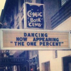 a sign that reads dancing now appearing the one percent