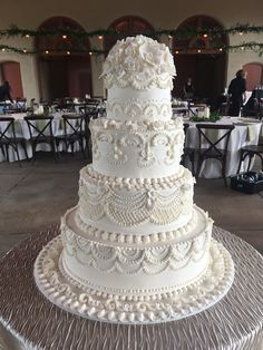 a large white wedding cake sitting on top of a table