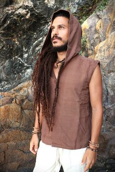 "Organic Plant Dyed Hooded Men Vest Comfy and casual Waistcoat/Vest made of hand loomed *khadi cotton and natural cotton lining. Wood buttons. Two outer pockets. You can find the Natural Khadi Cotton Pants here: https://www.etsy.com/uk/listing/1313710219/ SIZES S = 19 Inch Armpit to Armpit M = 20 \" \" \" L = 22 \" \" \" XL = 24 \" \" \" XXL= 26 \" \" \" COLOR Earthy Brown * Khadi is a traditional indian fabric made from handspun and handloomed cotton fibers. It is ethical guaranteeing the worke Brown Hooded Hoodie For Outdoor, Brown Hooded Cotton Top, Outdoor Brown Hoodie With Adjustable Hood, Brown Cotton Hooded Top, Brown Outdoor Hoodie With Drawstring Hood, Brown Outdoor Hoodie With Drawstring, Brown Hoodie With Drawstring For Outdoor, Brown Cotton Hooded Top With Drawstring, Brown Cotton Hoodie With Adjustable Hood