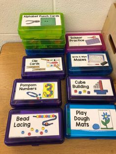 several plastic containers with different types of beads and matching labels on them sitting on a table