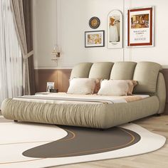 a large bed sitting on top of a wooden floor next to a white and brown rug