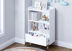 a white book shelf with stuffed animals on it in a child's room or playroom