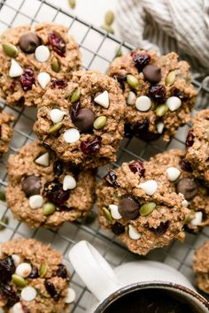 oatmeal cookies with nuts and cranberries are on a cooling rack