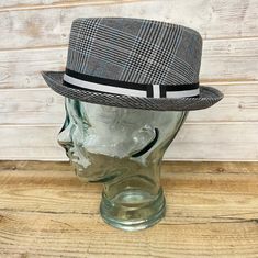 This GREY RUDE BOY SKA PORK PIE HAT with contrasting ribbon band detail is the most perfect hat for everyday, while still retaining the cool jazz associations of the pork pie style. This effortlessly great looking design features a 3cm brim (1.25 inches), and the eponymous flat crown has a height of 10cm (4 Inches) a timeless classic that will add a dapper dashing cool look The hat is CAREFULLY MADE from 100% Polyester and has a deep red paisley two tone silk look lining that enhances the look a Gray Short Brim Fedora For Spring, Gray Hat With Adjustable Fit And Short Brim, Gray Adjustable Hat With Short Brim, Adjustable Gray Retro Hat, Retro Adjustable Gray Hat, Pork Pie Hat, Cool Jazz, Pork Pie, Rude Boy