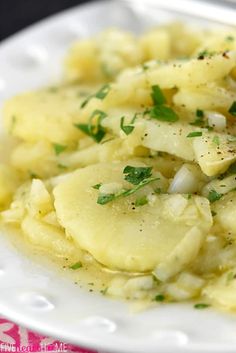 a white plate topped with potatoes and parsley