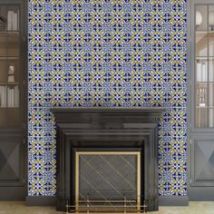 a fireplace in a room with blue and yellow tiles on the wall, next to a bookshelf