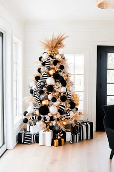 a black and white christmas tree with gold ornaments